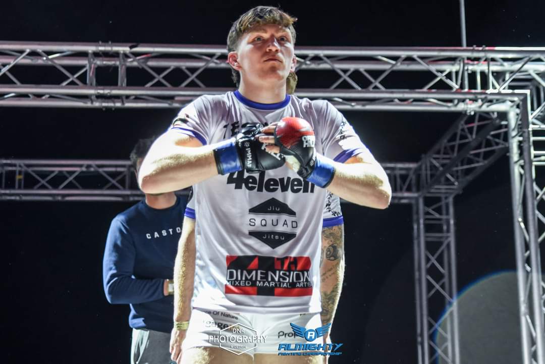 Fighter on the walkout ramp in a white 4 Eleven jiu jitsu squad rash guard